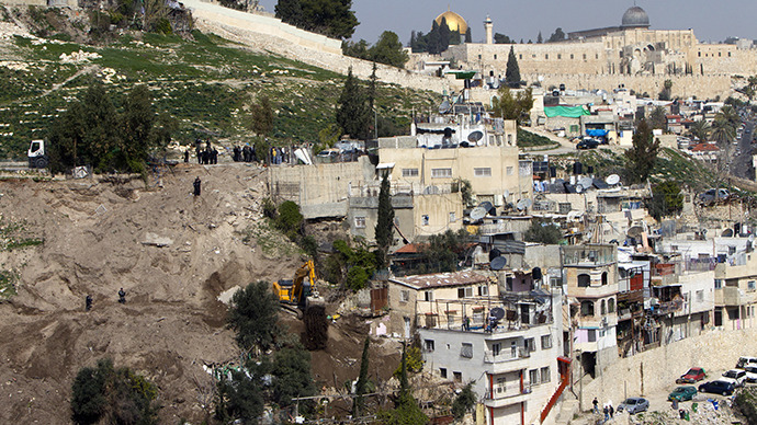 An Israeli army bulldozer destroys Palestinian houses in the east Jerusalem Arab neighbourhood of Silwan in JerusalemТs old city on January 28, 2013. (AFP Photo / Ahmad Gharabli)