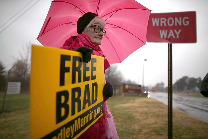 Danielle Green from the Bradley Manning Support Group, holds a sign during a rally at the entrance to Fort George G. Meade on November 27, 2012. (AFP Photo / Mark Wilson)