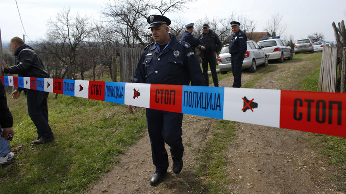 A policeman stands guard in the village of Velika Ivanca, about 40 km (25 miles) southwest of Belgrade April 9, 2013. (Reuters/Marko Djurica)