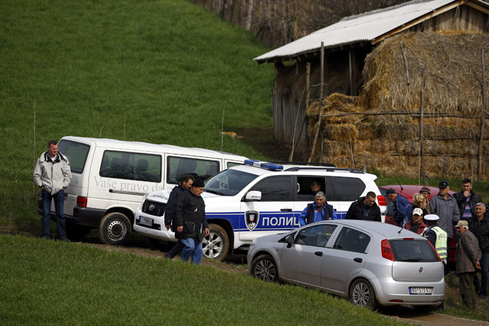 Police and residents are pictured in the village of Velika Ivanca, about 40 km (25 miles) southwest of Belgrade April 9, 2013. (Reuters/Marko Djurica)