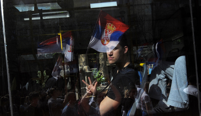 A man in a bus gestures to a group of Serbian ultra nationalists during a protest on April 21, 2013, in Belgrade. Serbia (AFP Photo / Alexa Stankovic) 