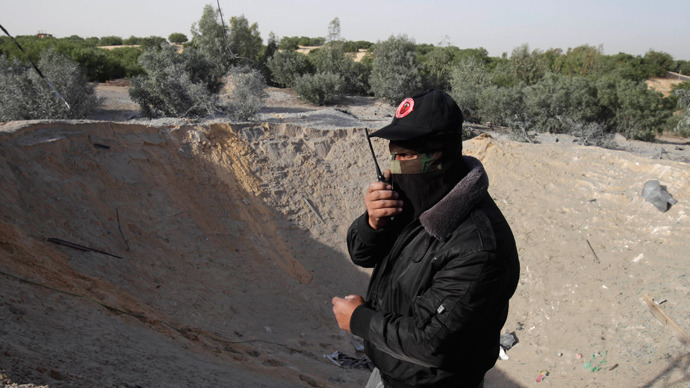 A Palestinian member of the Democratic Front for the Liberation of Palestine (DFLP) inspects a training base after it was hit by an Israeli air strike in Rafah in the southern Gaza Strip April 28, 2013 (Reuters / Ibraheem Abu Mustafa)