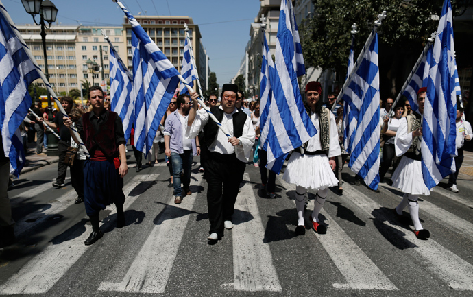 Municipal workers dressed in traditional costumes protest against the government’s plan to layoff thousands of public sector workers as part of its austerity reform program, in Athens April 26, 2013 (Reuters / John Kolesidis)