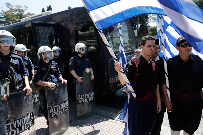 Municipal workers dressed in traditional costumes protest against the government’s plan to layoff thousands of public sector workers as part of its austerity reform program, in Athens April 26, 2013 (Reuters / John Kolesidis)