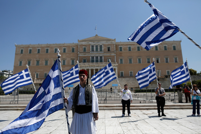 A municipal worker dressed in a traditional costume protests against the government's plan to layoff thousands of public sector workers as part of its austerity reform program, outside the parliament in Athens April 26, 2013 (Reuters / John Kolesidis)