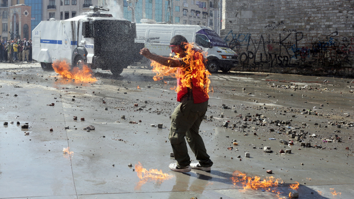 A demonstrator's clothes are set on fire during clashes with riot police in Taksim square on June 11, 2013 (AFP Photo / Oren Ziv) 