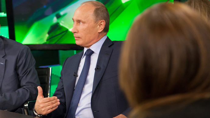Russian President Vladimir Putin, center, during his talk with Russia Today television channel's journalists and correspondents, June 11, 2013. (RT photo / Semyon Khorunzhy)