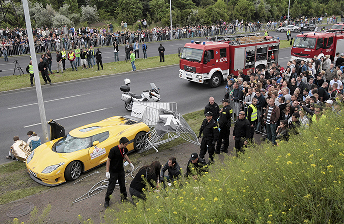 Emergency service workers help people wounded in an accident at Gran Turismo Polonia in Poznan June 30, 2013. (Reuters / Agencja Gazeta)