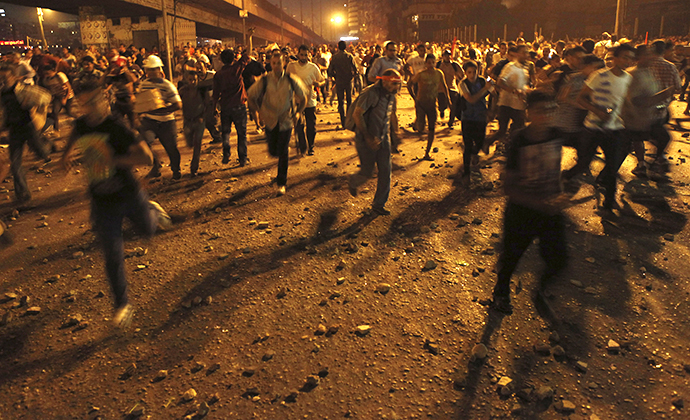 Anti-Mursi protesters run during clashes with members of the Muslim Brotherhood and supporters of ousted Egyptian President Mohamed Morsi near Maspero, Egypt's state TV and radio station, near Tahrir square in Cairo July 5, 2013. (Reuters / Amr Dalsh)