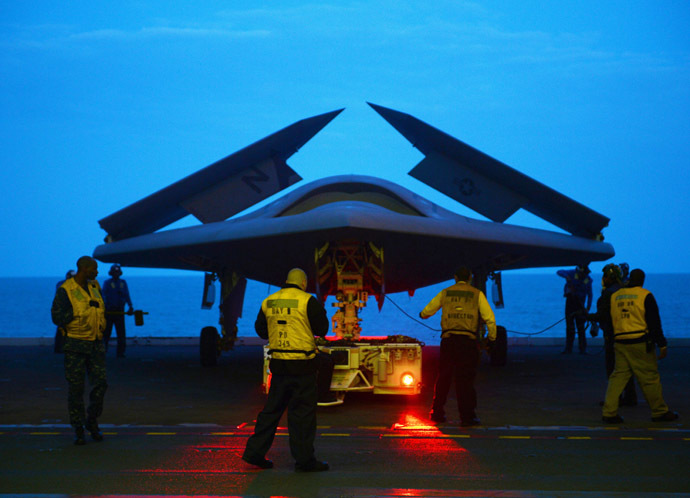 This May 13, 2013 US Navy handout image shows an X-47B Unmanned Combat Air System (UCAS) demonstrator being towed into the hangar bay of the aircraft carrier USS George H.W. Bush (CVN 77) during operations in the Atlantic Ocean. (AFP Photo/US Navy)