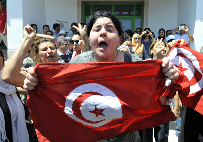 Belkaeis Brahimi, the daughter of Tunisian opposition politician Mohamed Brahmi, shows a national flag shouting outside a hospital after her father was killed on July 25, 2013 in Ariana, outside Tunis (AFP Photo)
