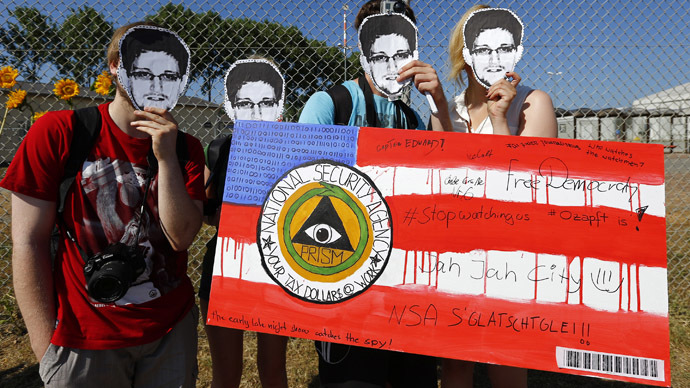 Protesters wearing masks of U.S. whistleblower Edward Snowden hold a sign disparaging the National Security Agency (NSA) outside the "Dagger Complex", which is used by the U.S. Army intelligence services, during a demonstration against the NSA and in support of Snowden in Griesheim, 20km (12.4 miles) south of Frankfurt, July 20, 2013. (Reuters/Kai Pfaffenbach) 