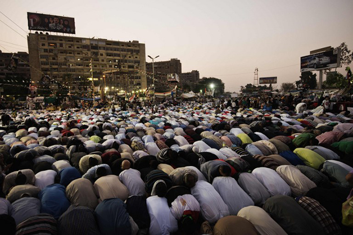 Muslim Brotherhood members and supporters of deposed president Mohamed Morsi pray after breaking their fast during a rally outside Rabaa al-Adawiya mosque on July 15, 2013 in Cairo, Egypt. (AFP Photo / Gianluigi Guercia)