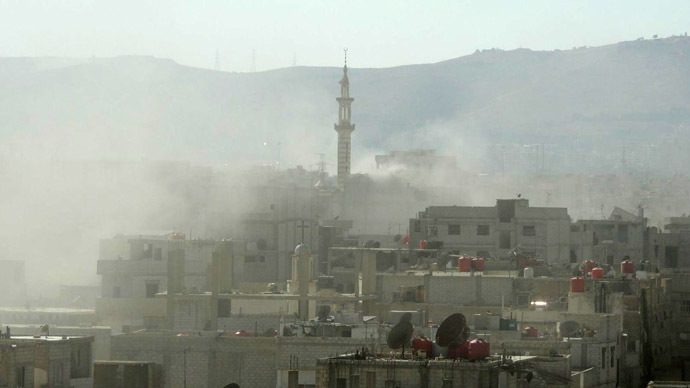 A handout image released by the Syrian opposition's Shaam News Network shows smoke above buildings following what Syrian rebels claim to be a toxic gas attack by pro-government forces in eastern Ghouta, on the outskirts of Damascus on August 21, 2013.  (AFP Photo/Shaam News Network)