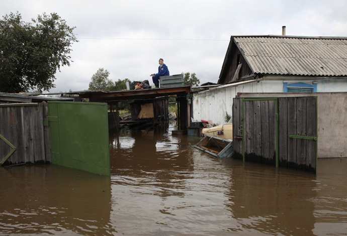 A woman sits on the roof of her flooded dwelling outside Komosomolsk-on-Amur in Russia's far eastern Khabarovsk region, September 7, 2013. (Reuters/Vladimir Barsukov)