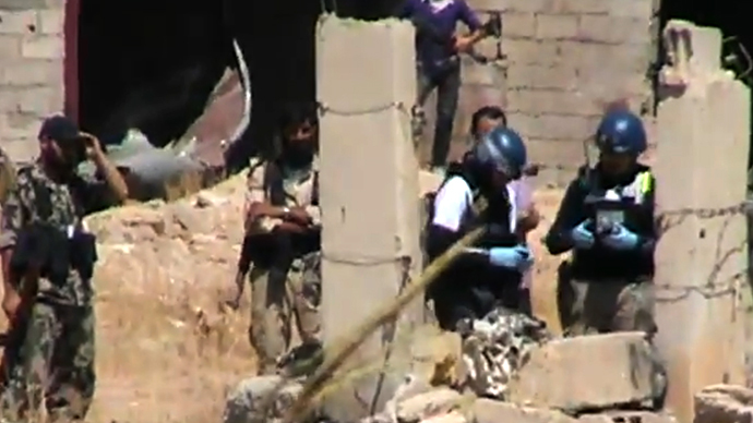 An image grab taken from a video uploaded on YouTube by Harasta Media Centre on August 28, 2013 allegedly shows opposition fighters standing next to a United Nations (UN) arms expert as they collect information during an investigation into a suspected chemical weapons attack in Damascus' eastern Ghouta suburb. (AFP Photo)