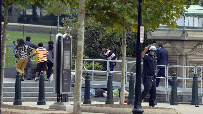 People take cover as gun shoot being heard at the Capitol in Washington, DC, on October 3, 2013.(AFP Photo / Jewel Samad) 