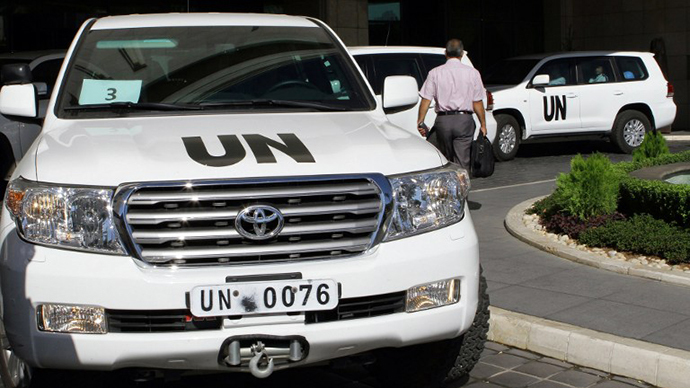 United Nations vehicles are seen leaving the hotel in Damascus on October 3, 2013. (AFP Photo / Louai Beshara)