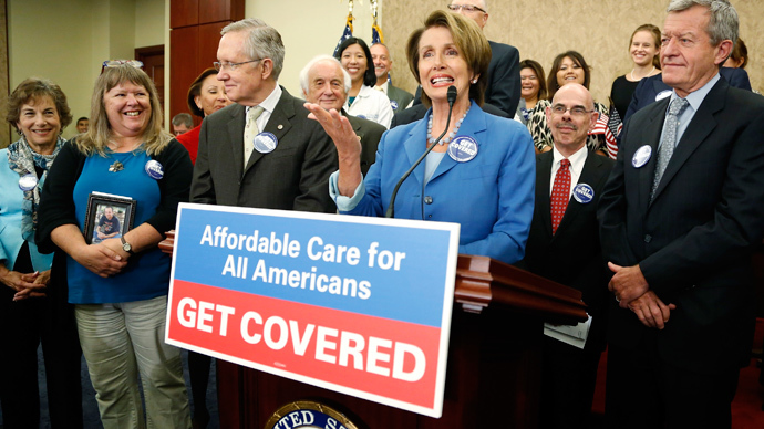 U.S. House Minority Leader Nancy Pelosi (3rd R) and Senate Democratic leader Harry Reid (3rd L) lead a rally to celebrate the start of the Affordable Care Act (commonly known as Obamacare) at the U.S. Capitol in Washington (Reuters / Jonathan Ernst) 