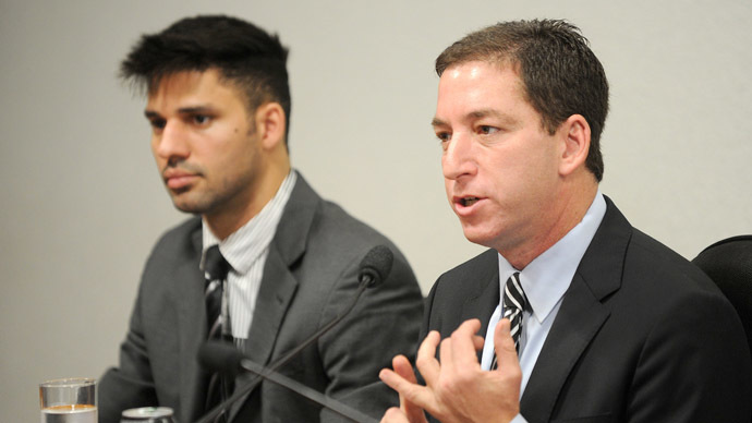 The Guardian's Brazil-based reporter Glenn Greenwald (R), who was among the first to reveal Washington's vast electronic surveillance program, accompanied by his partner David Miranda, testifies before the investigative committee of the Senate that examines charges of espionage by the United States in Brasilia on October 9, 2013, following press reports of US electronic surveillance in Brazil based on leaks from Edward Snowden, a former US National Security Agency contractor. (AFP Photo/Evaristo Sa)