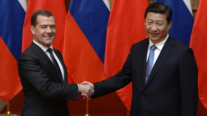 Russian Prime Minister Dmitry Medvedev (L) shakes hands with Chinese President Xi Jinping (R) before a meeting at the Great Hall of the People in Beijing on October 22, 2013. (AFP Phoro/Kota Endo)