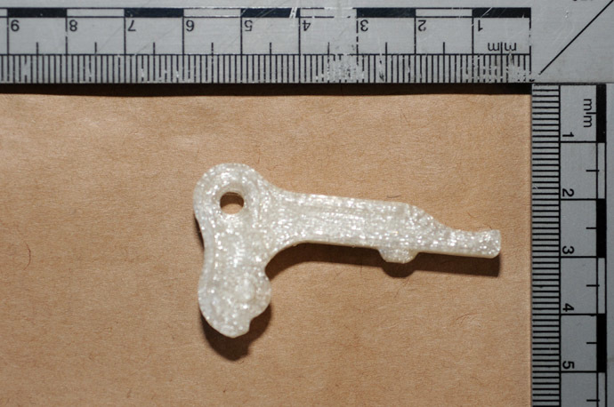 A handout picture taken on October 24, 2013 and released by Greater Manchester Police on October 25, 2013 shows a plastic component that British police suspect to be a trigger that could be used to make a viable 3D-printed gun, seized by police during searches as part of an operation in the Baguley area of Manchester, northwest England on October 24, 2013. (AFP Photo)