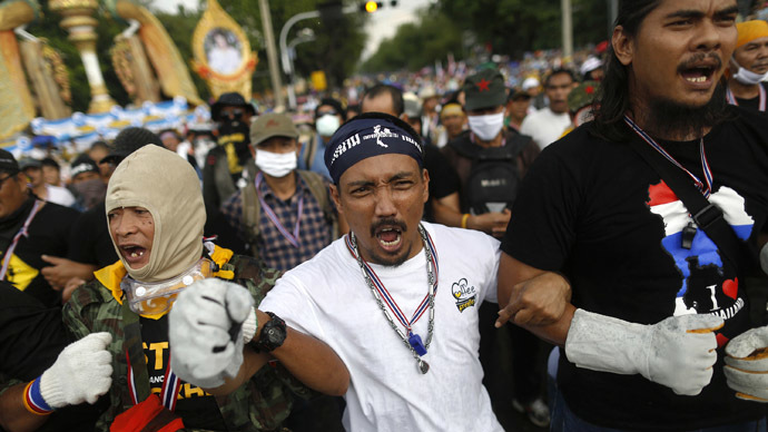 Anti-government protesters shout as they get ready to attack a police barricade near the Government house in Bangkok November 25, 2013. (Reuters/Damir Sagolj)