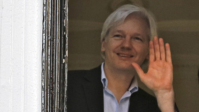 WikiLeaks founder Julian Assange waves from a window at Ecuador's embassy in central London (Reuters/Chris Helgren)