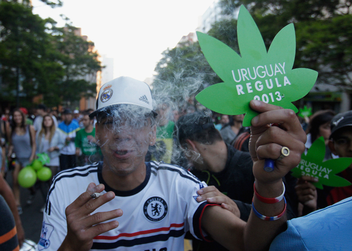People participate in the so-called "Last demonstration with illegal marijuana" on their way to the Congress building in Montevideo, as Senate debates a government-sponsored bill establishing state regulation of the cultivation, distribution and consumption of marijuana during a session, December 10, 2013. (Reuters / Andres Stapff )