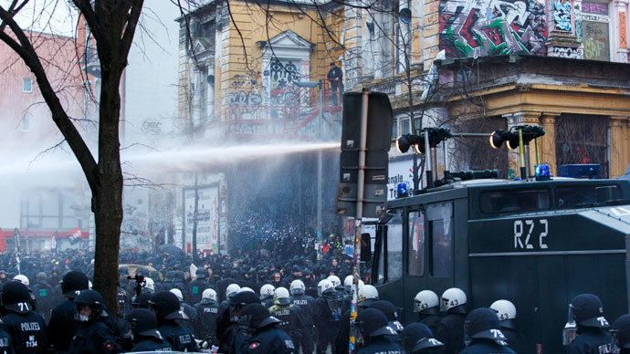 German police use water cannons to clear a street following clashes in front of the 'Rote Flora' cultural centre during a demonstration in Hamburg, December 21, 2013.(Reuters / Morris Mac Matzen)