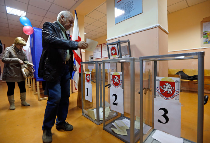 A man prepares to cast his ballot during the referendum on the status of Ukraine's Crimea region at a polling station in Simferopol March 16, 2014. (Reuters / Vasily Fedosenko)