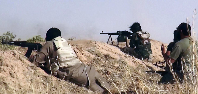 An image made available by the jihadist Twitter account Al-Baraka news on June 13, 2014 allegedly shows Islamic State of Iraq and the Levant (ISIL) militants clashing with Iraqi soldiers at an undisclosed location close to the Iraqi-Syrian border, in the district of Sinjar, northwest Iraq. (AFP Photo)
