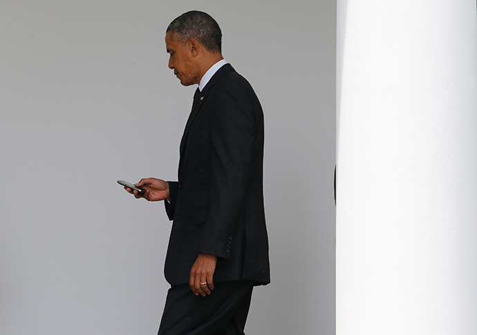 President Barack Obama checks his Blackberry smartphone (Reuters / Jim Bourg)