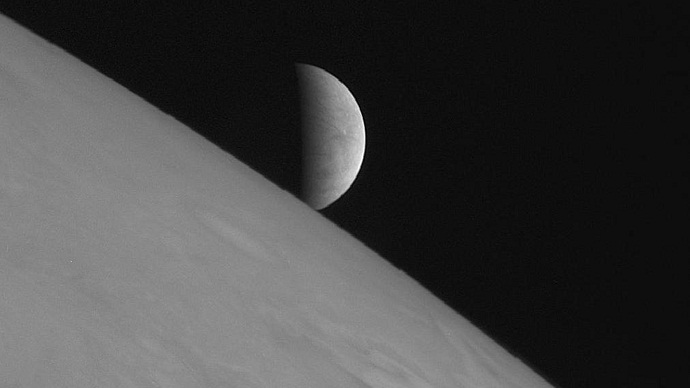 New Horizons took this image of the icy moon Europa rising above Jupiter's cloud tops after the spacecraft's closest approach to Jupiter (Image by Reuters/NASA)