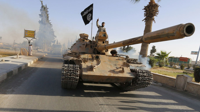 Combatentes islâmicos militantes em um tanque de participar de um desfile militar pelas ruas da província do norte Raqqa 30 de junho de 2014 (Reuters)