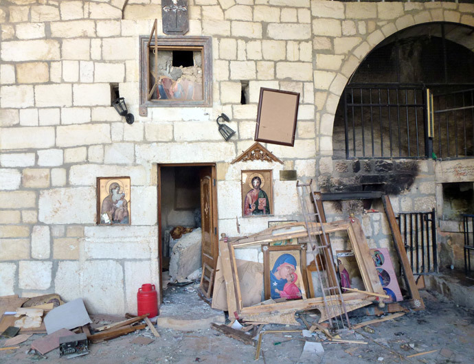 Destroyed religious icons are pictured inside a church in the ancient Christian town of Maalula on April 20, 2014. (AFP Photo / Rim Haddad)