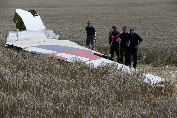 Members of a group of international experts inspect wreckage at the site where the downed Malaysia Airlines flight MH17 crashed, near the village of Hrabove (Grabovo) in Donetsk region, eastern Ukraine August 1, 2014. (Reuters/Sergei Karpukhin)
