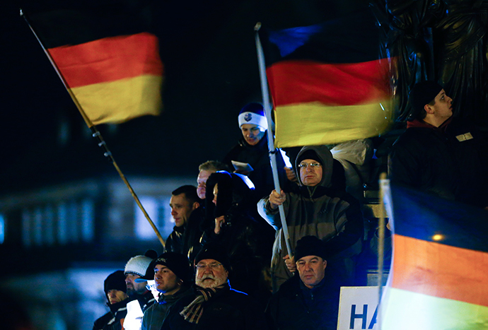 Participants hold German national flags during a demonstration called by anti-immigration group PEGIDA, a German abbreviation for "Patriotic Europeans against the Islamization of the West", in Dresden December 22, 2014. (Reuters / Hannibal Hanschke)