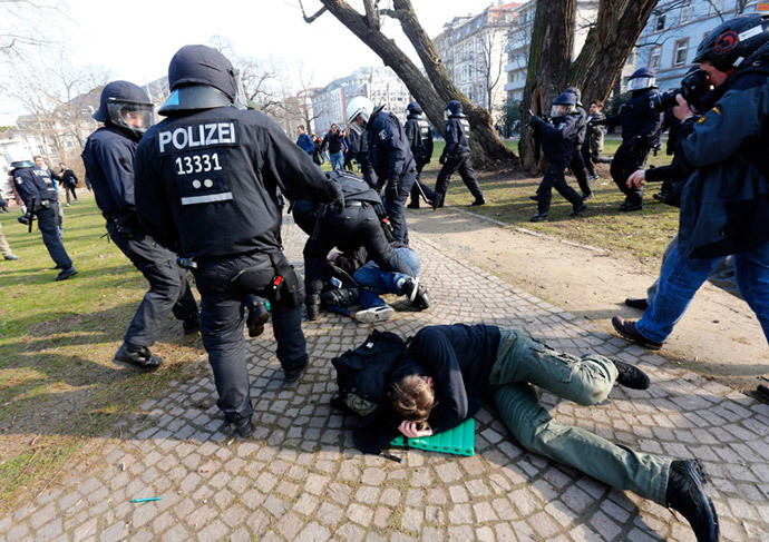 Policemen detain members of 'Blockupy' anti-capitalist movement near the European Central Bank (ECB) building before the official opening of its new headquarters in Frankfurt March 18, 2015. (Reuters / Michael Dalder)