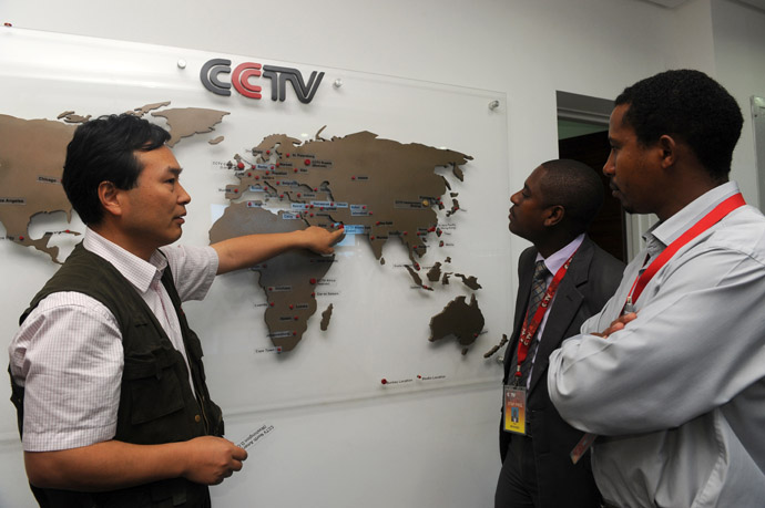 This picture taken on June 12, 2012 shows the managing editor of China Central Television (CCTV) Africa Pang Xinhua (L) talking to local journalist as he shows them how the organization has expanded in different parts of Africa, in the premises of the television in Nairobi. (AFP Photo/Simon Maina)