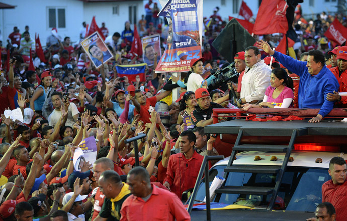 Venezuelan President Hugo Chavez (R) waves to supporters during a campaign rally in Barquisimeto, Lara state on October 2, 2012. (AFP Photo/Juan Barreto)