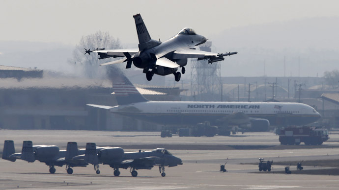 An A-10 jet (top) belonging to the U.S. Air Force comes in for a landing at a U.S. air force base in Osan, south of Seoul April 3, 2013.  (Reuters/Lee Jae-Won)