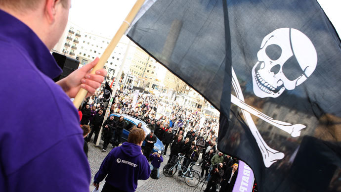 A supporter of file-sharing hub The Pirate Bay, waves a Jolly Roger flag during a demonstration in Stockholm.(Reuters / Fredrik Persson)