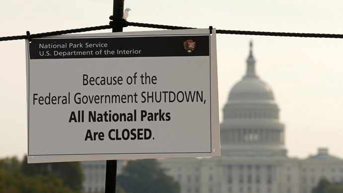 The U.S. Capitol looms in the background of a sign on the National Mall reminding visitors of the closures to all national parks due to the federal government shutdown in Washington October 3, 2013. (Reuters/Kevin Lamarque)