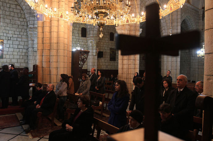 Syrian Christians attend Christmas Day mass at the Saint George Monastery in Mishtaya, some 50 kms from Homs, on December 25, 2011.(AFP Photo / Louai Beshara)