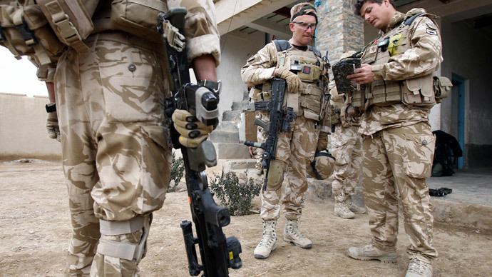 British soldier Lieutenant-Colonel Nick Lock (C) checks his equipment before conducting a patrol with soldiers of the 1st Batallion of the Royal Welsh in streets of Showal in Nad-e-Ali district, Southern Afghanistan, in Helmand Province.(AFP Photo / Thomas Coex )
