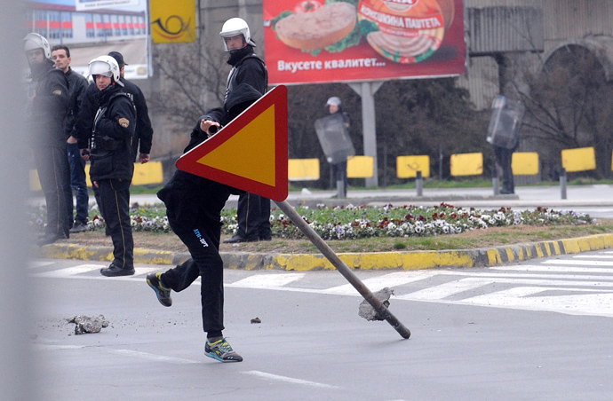 An Ethnic Albanian carry a road sign during clashes with Macedonian riot police in Skopje on March 2, 2013 (AFP Photo / Robert Atanasovski)
