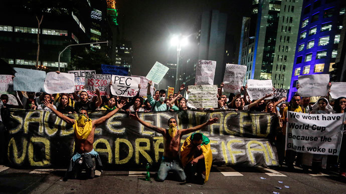 Demonstrators hold a banner demanding an improvement for education and health in Sao Paulo, Brazil, on June 20, 2013.(AFP Photo / Miguel Schincariol)