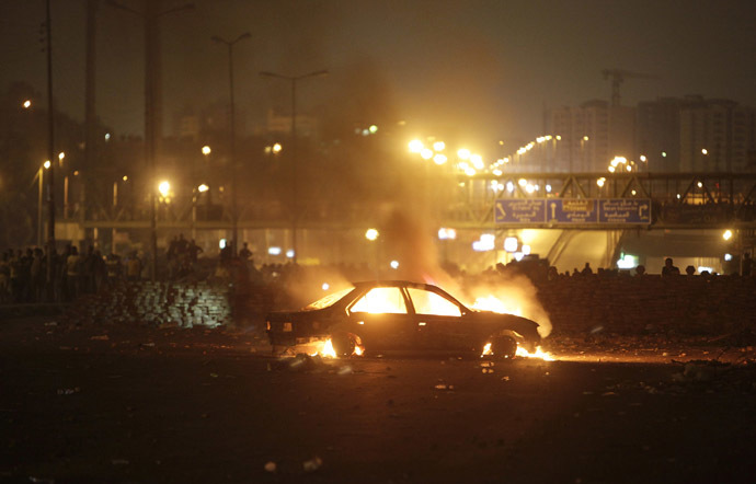 A car that members of the Muslim Brotherhood and supporters of deposed Egyptian President Mohamed Mursi say was burnt by police and plain-clothed people is seen during clashes in Nasr city area, east of Cairo July 27, 2013. (Reuters/Asmaa Waguih)