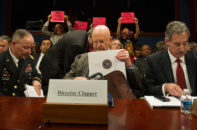 Protesters with the organization Code Pink hold up placards as Director of National Security Agency (NSA) and Commander of US Cyber Command General Keith Alexander (L), Director of National Intelligence James Clapper (C) and Deputy Attorney General James Cole (R) arrive to testify before the House (Select) Intelligence Committee on "Potential Changes to the Foreign Intelligence Surveillance Act (FISA)" on Capitol Hill in Washington, DC, October 29, 2013 (AFP Photo / Jim Watson)